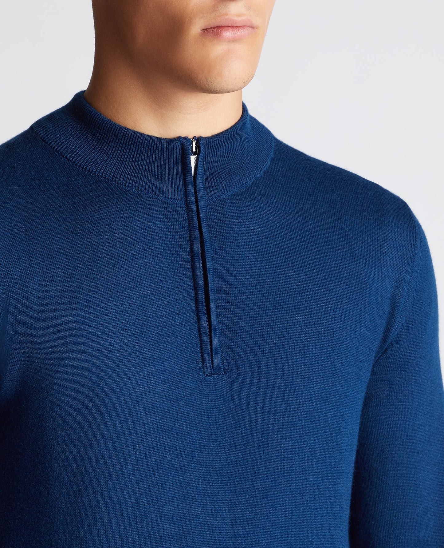 Man wearing a blue Tapered Fit Merino Wool-Blend Half Zip Sweater