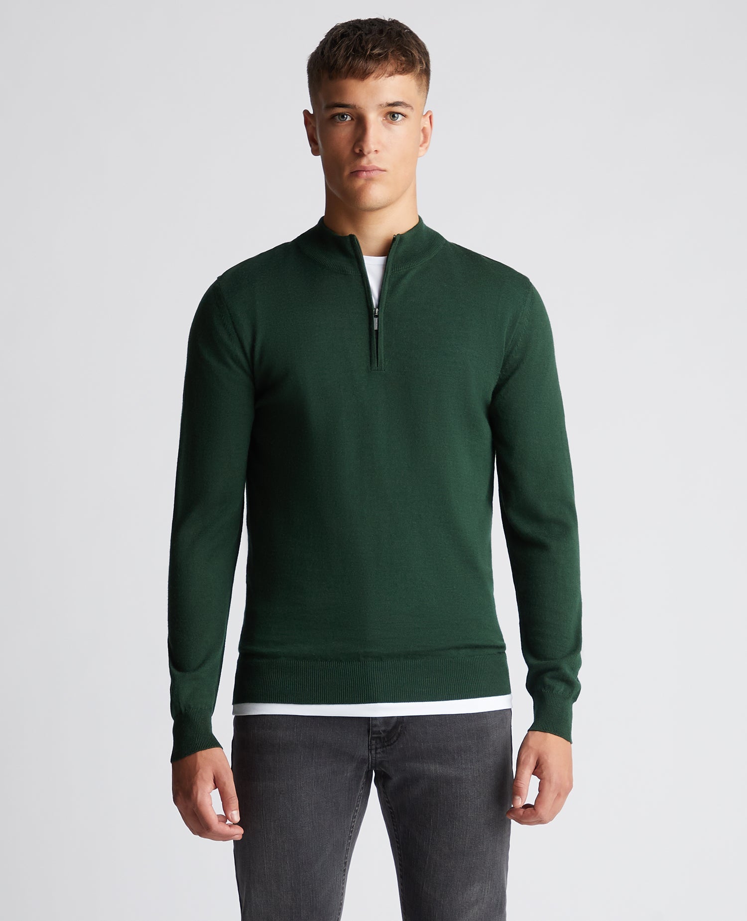 Man wearing a green Tapered Fit Merino Wool-Blend Half Zip Sweater