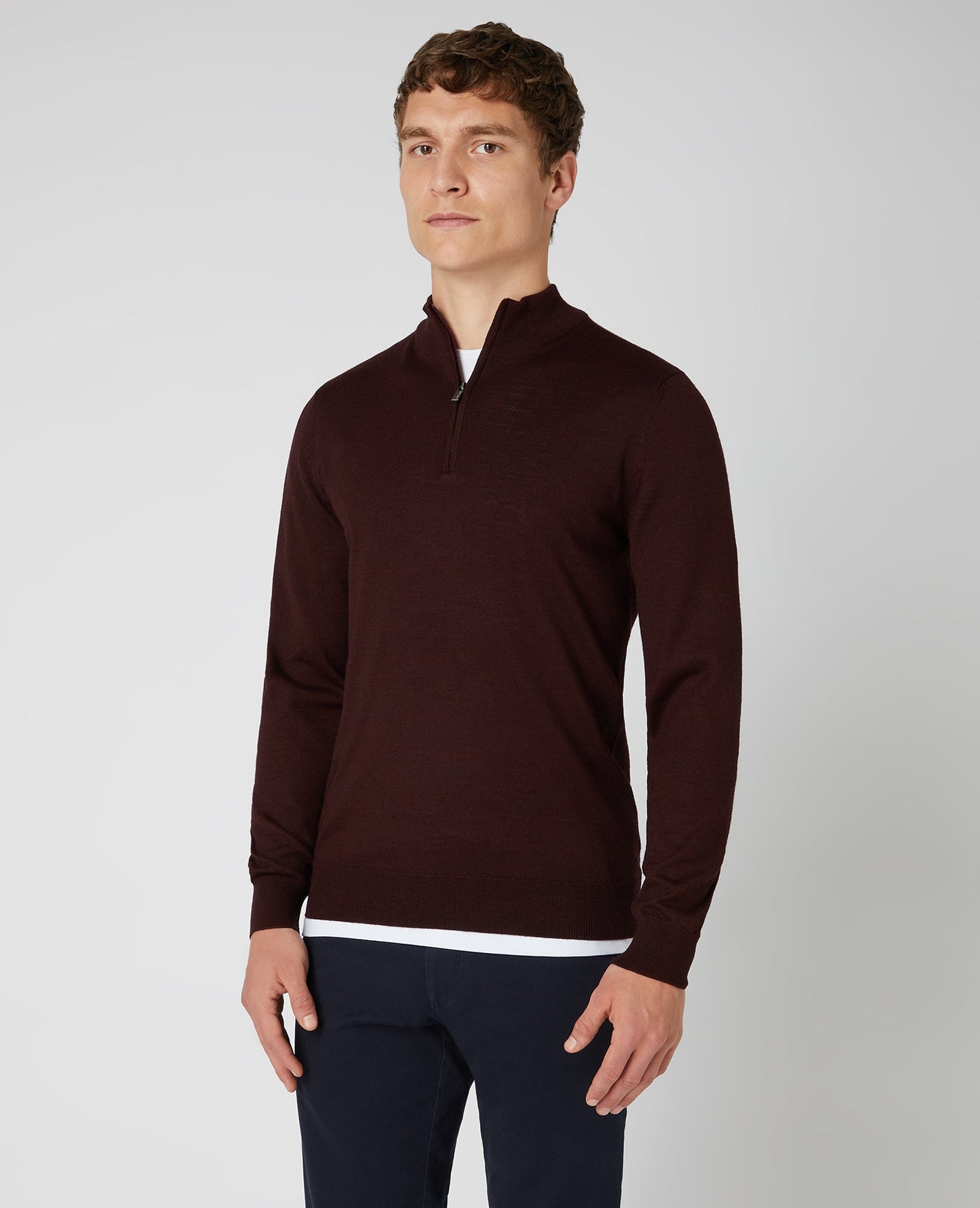 Man wearing a red Tapered Fit Merino Wool-Blend Half Zip Sweater