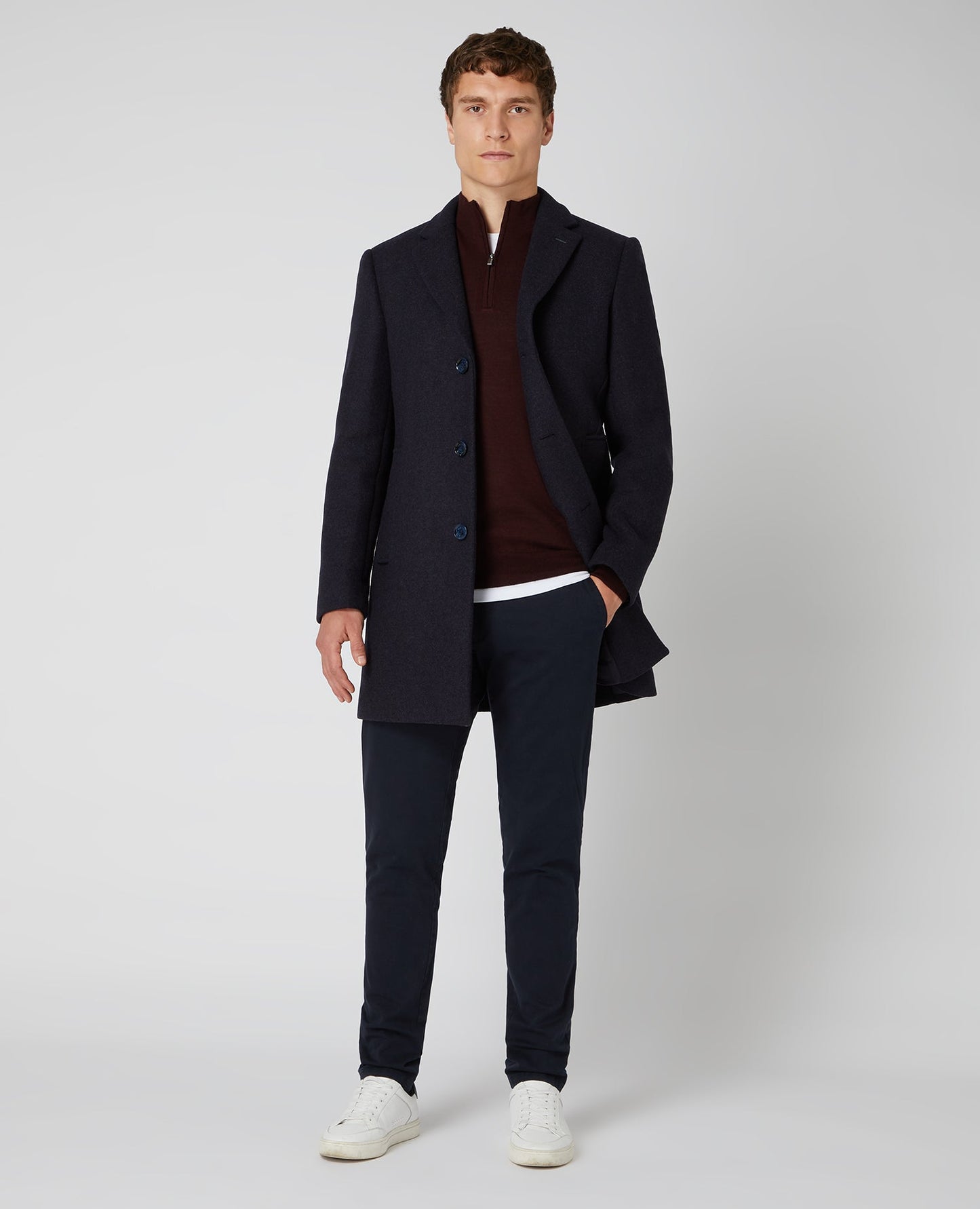 Man wearing a red Tapered Fit Merino Wool-Blend Half Zip Sweater