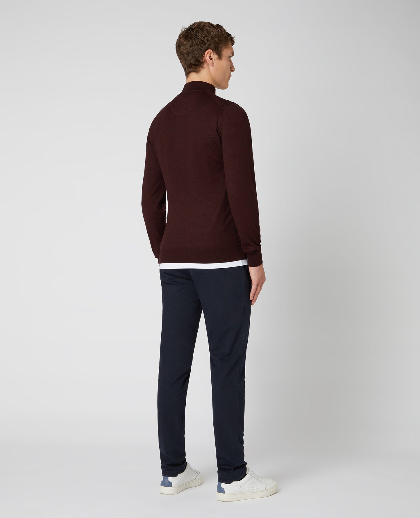 Man wearing a red Tapered Fit Merino Wool-Blend Half Zip Sweater