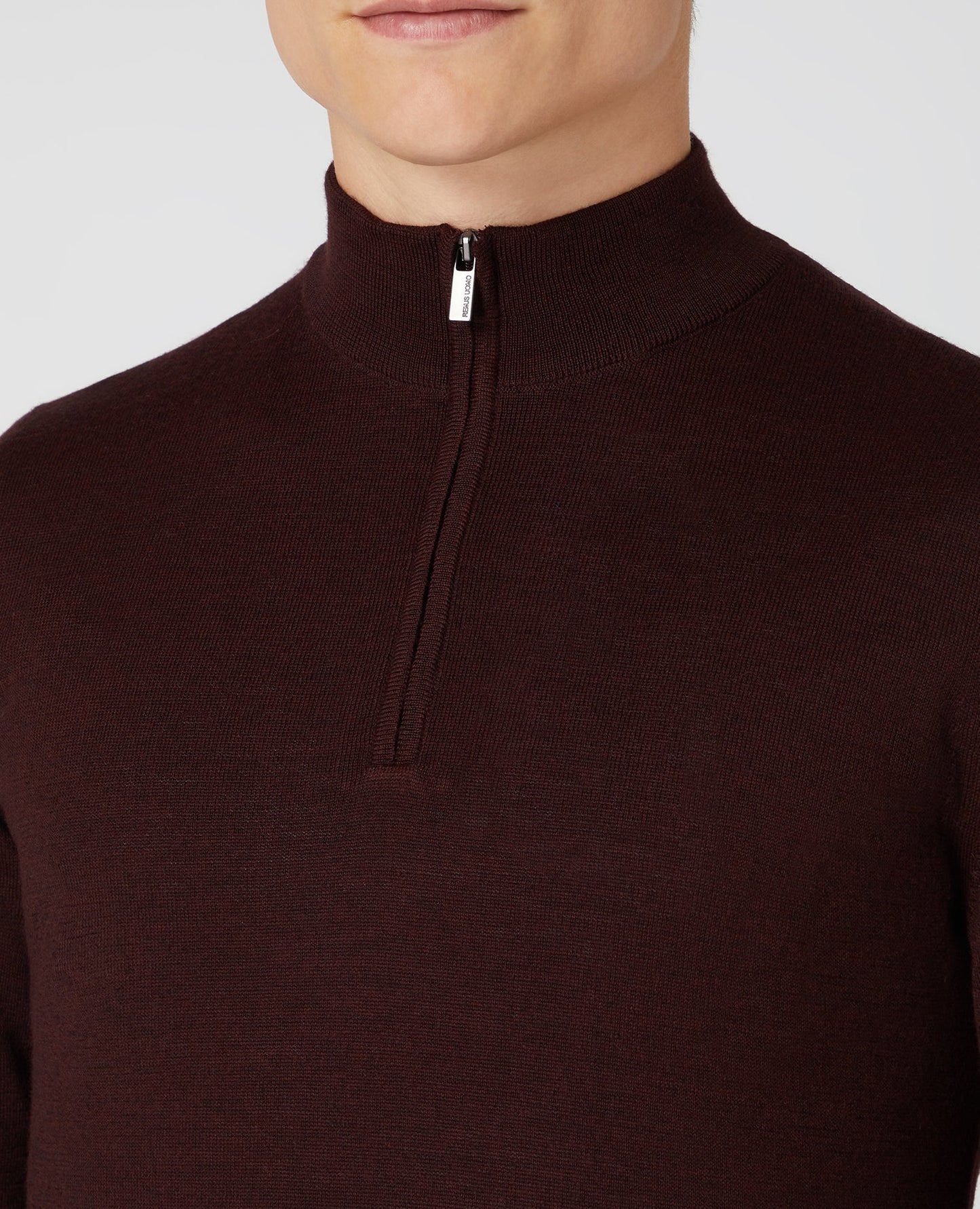 Man wearing a red Tapered Fit Merino Wool-Blend Half Zip Sweater