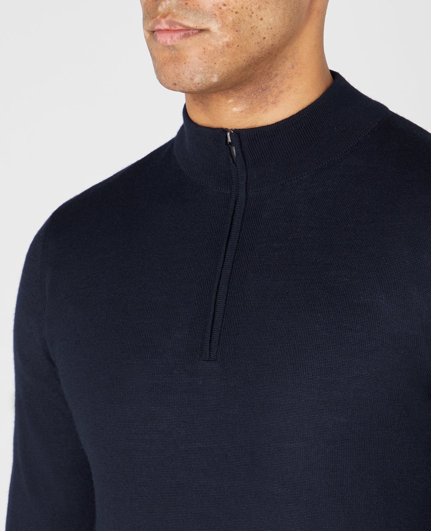 Man wearing a navy Tapered Fit Merino Wool-Blend Half Zip Sweater