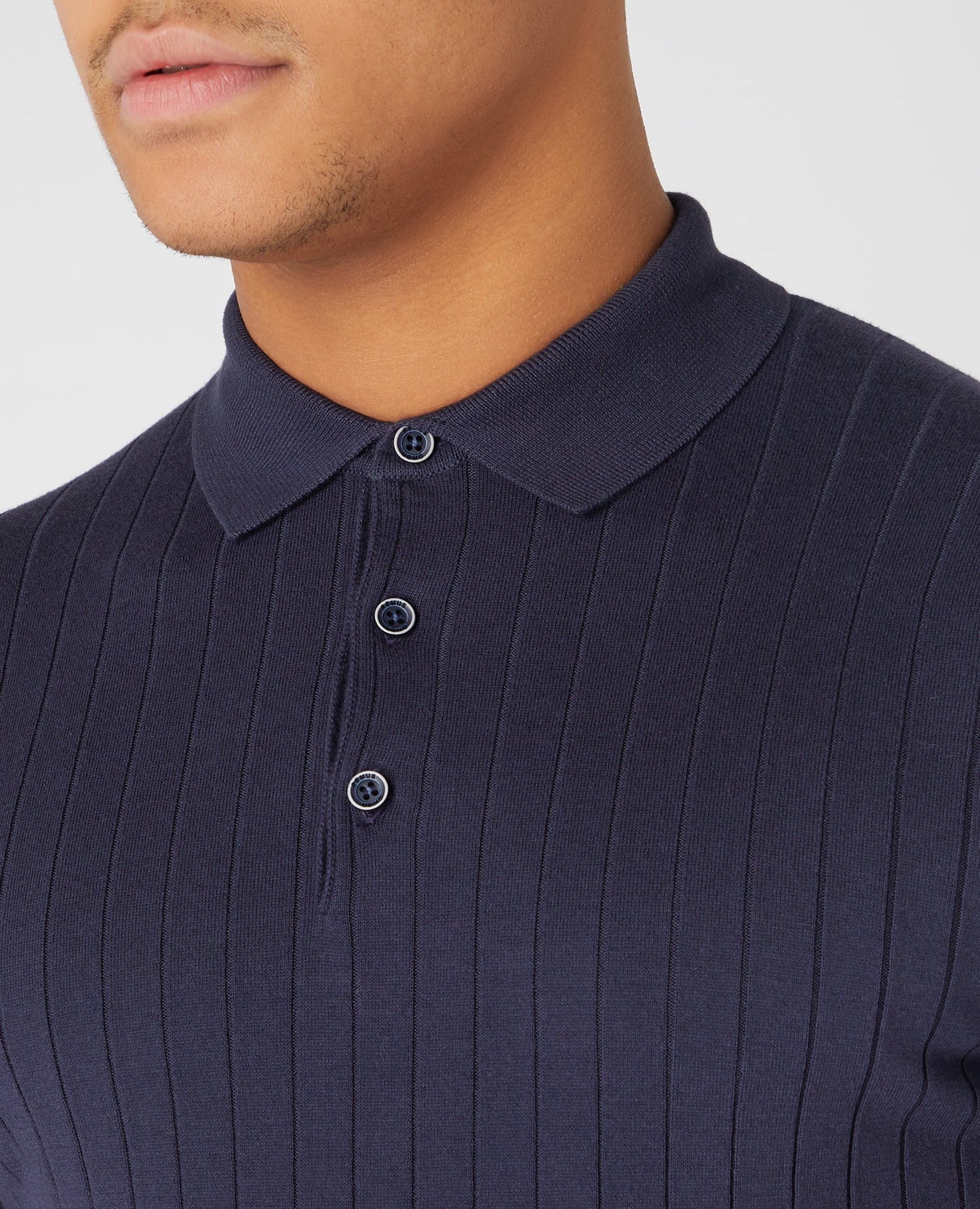 Man wearing a navy Slim Fit Knitted Cotton Short-Sleeve Polo Shirt