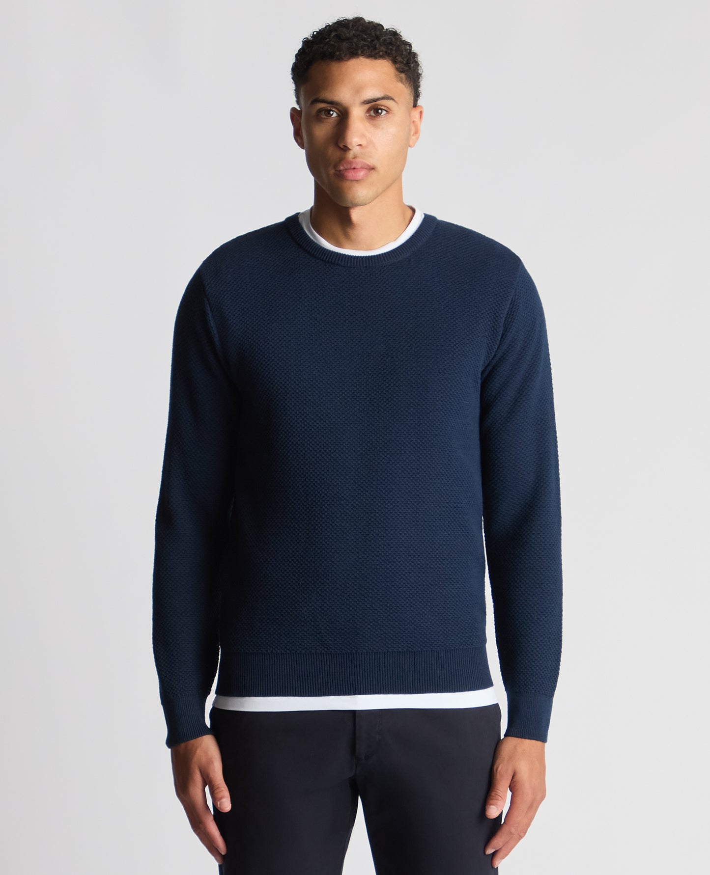 Man wearing a blue Tapered Fit Merino Wool-Blend Sweater