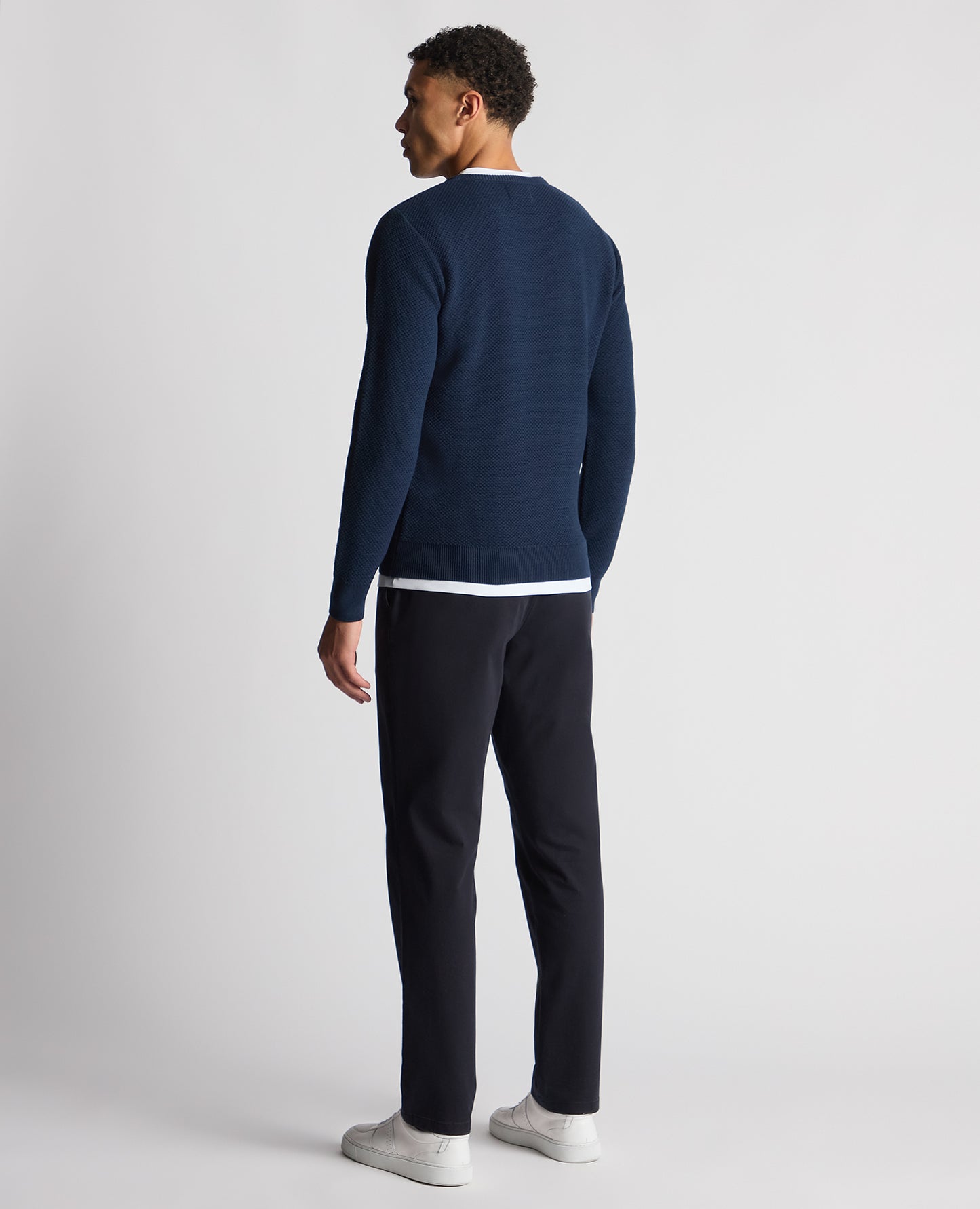 Man wearing a blue Tapered Fit Merino Wool-Blend Sweater