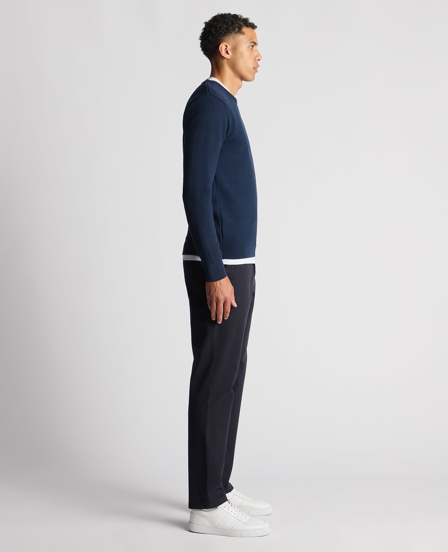 Man wearing a blue Tapered Fit Merino Wool-Blend Sweater