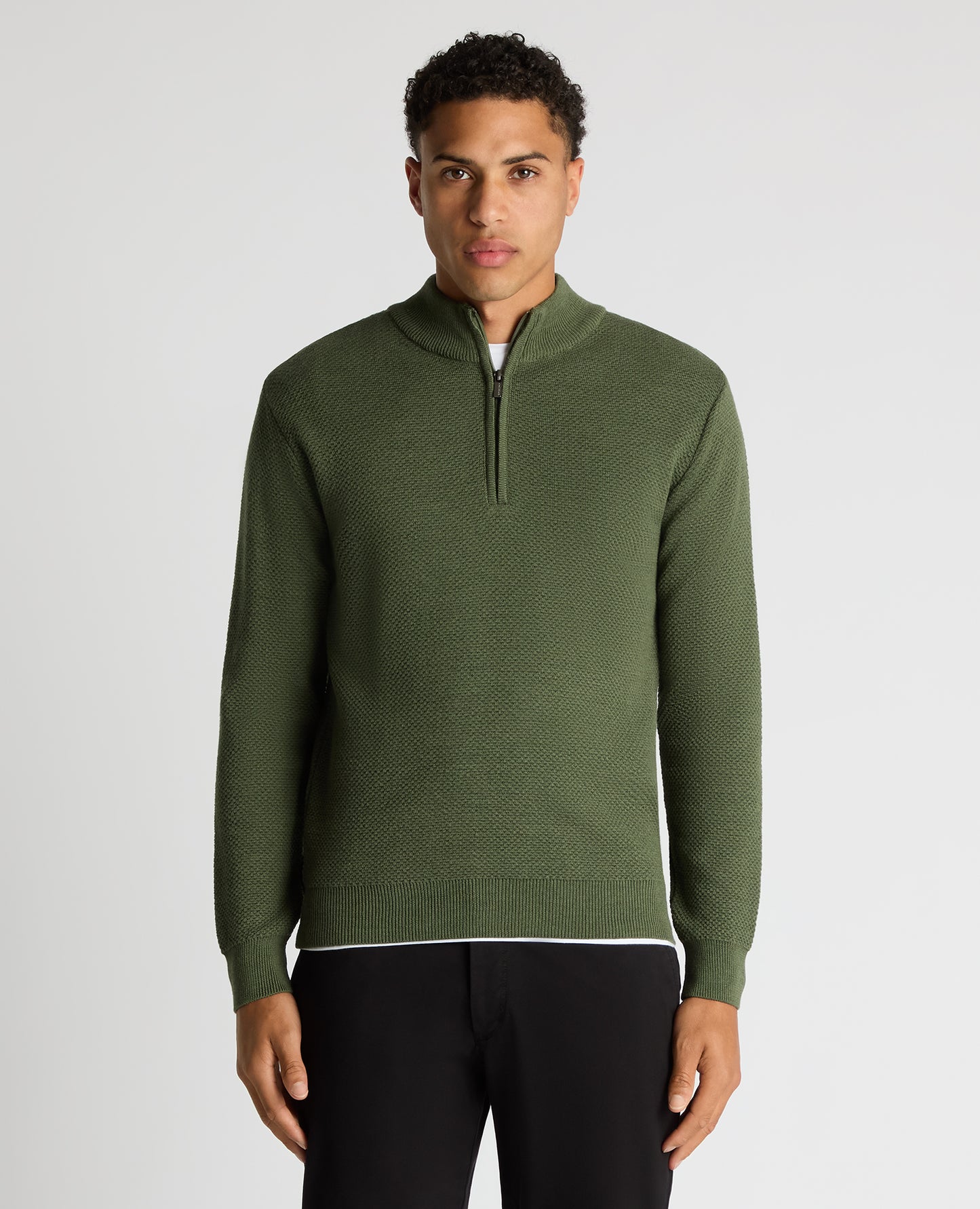 Man wearing a green Tapered Fit Merino Half Zip Sweater