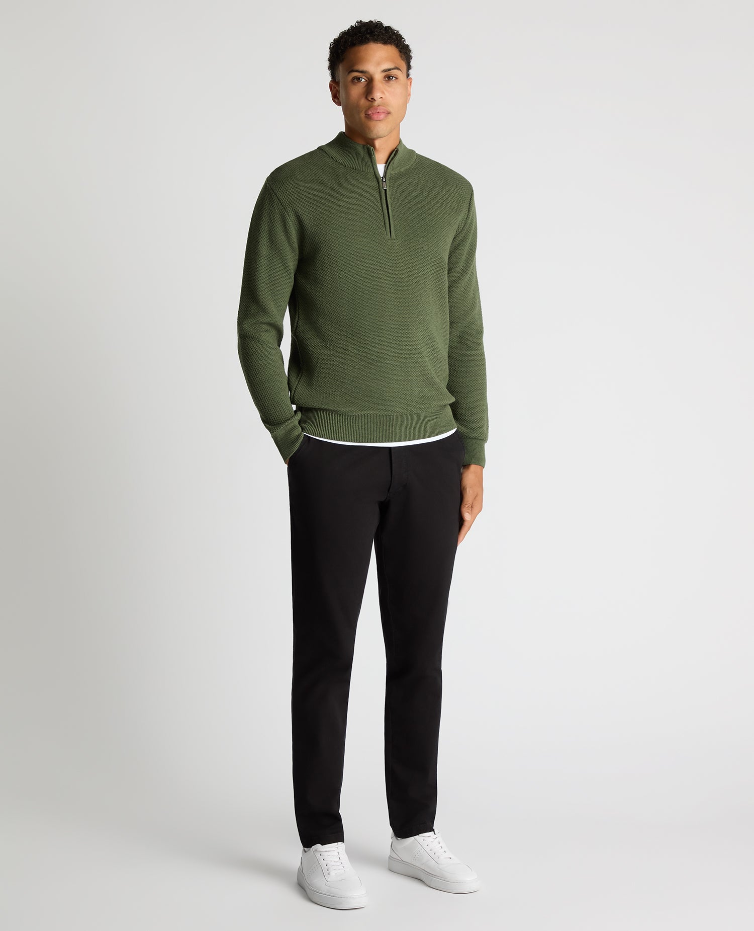 Man wearing a green Tapered Fit Merino Half Zip Sweater