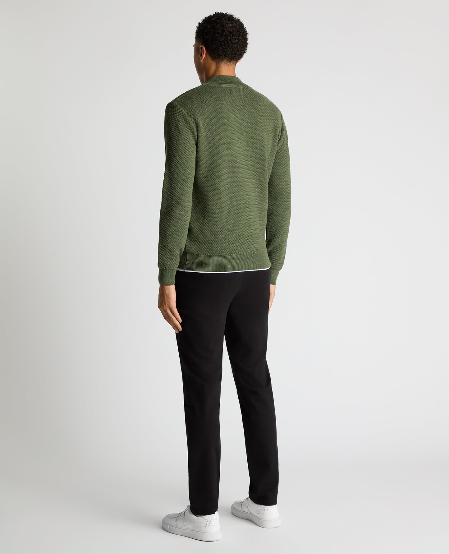 Man wearing a green Tapered Fit Merino Half Zip Sweater