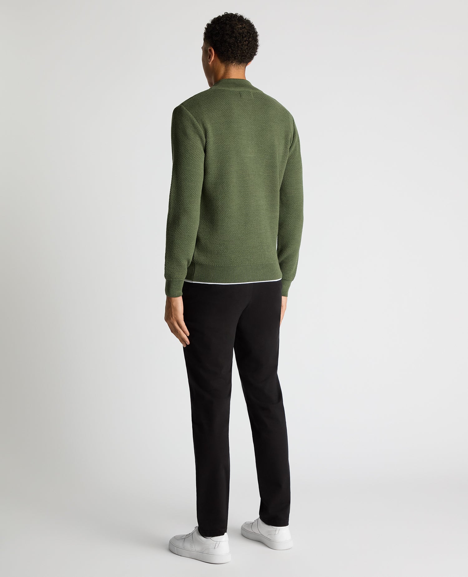 Man wearing a green Tapered Fit Merino Half Zip Sweater