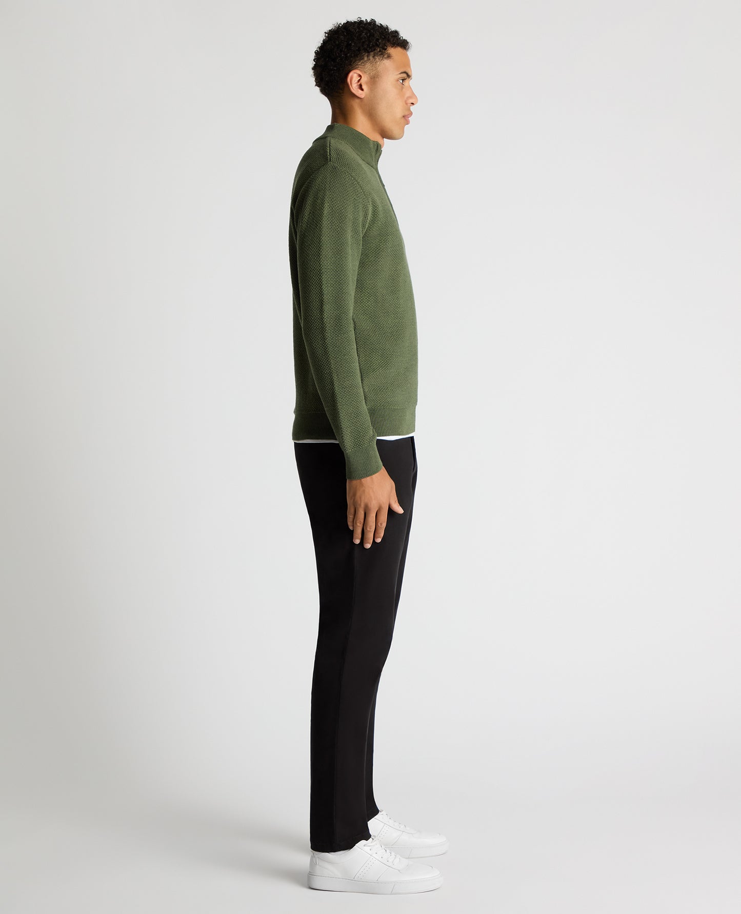Man wearing a green Tapered Fit Merino Half Zip Sweater