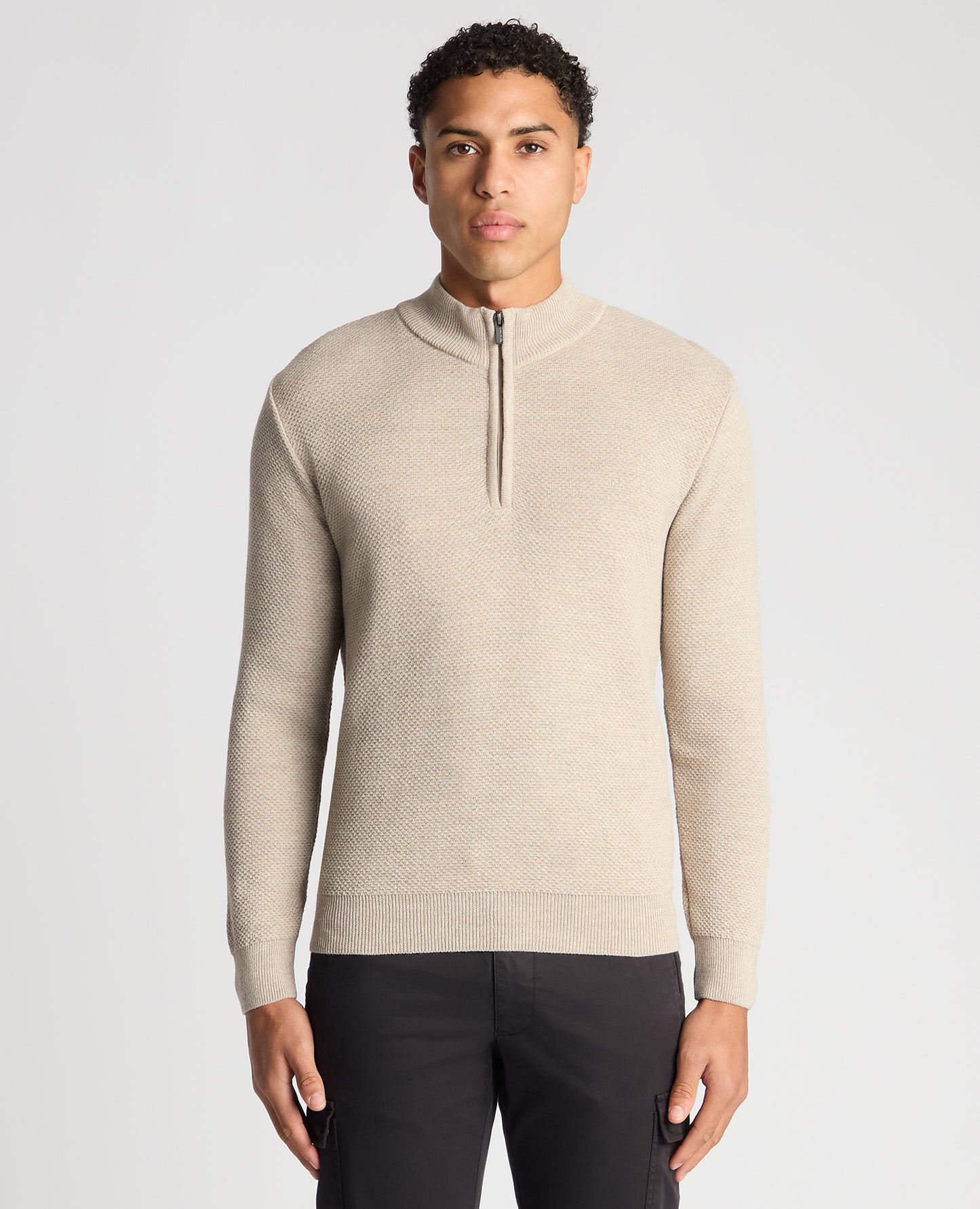 Man wearing a sand Tapered Fit Merino Half Zip Sweater