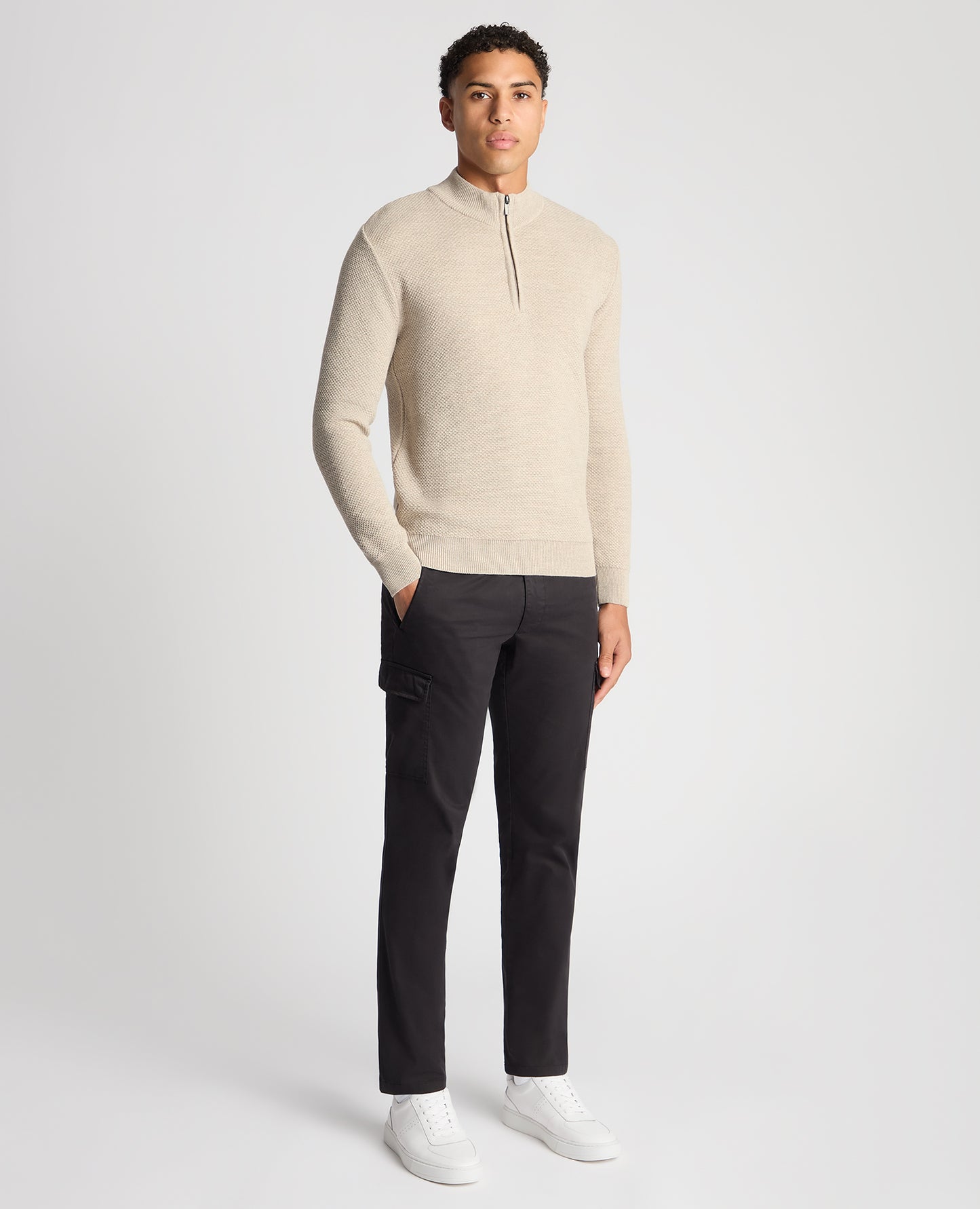Man wearing a sand Tapered Fit Merino Half Zip Sweater