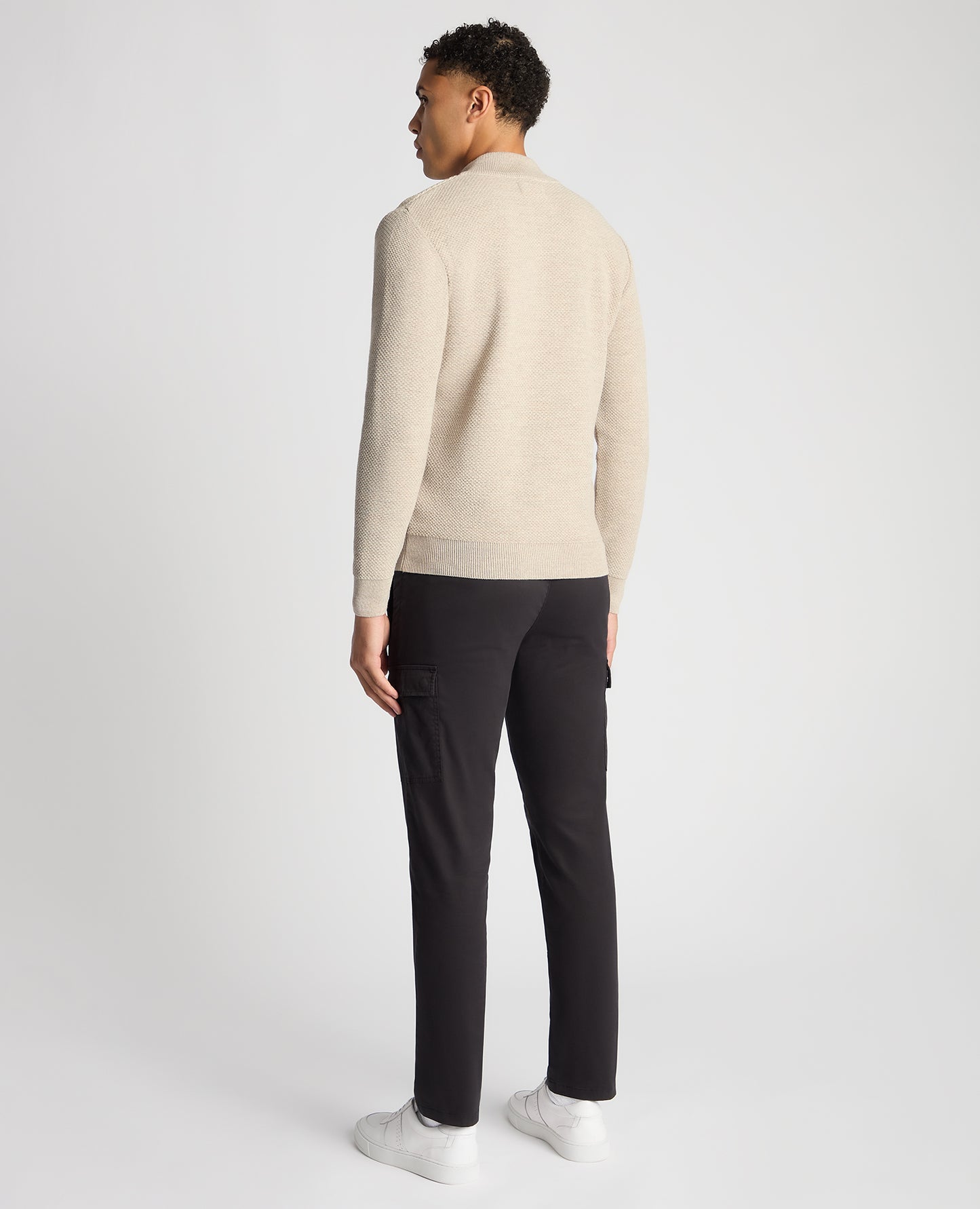 Man wearing a sand Tapered Fit Merino Half Zip Sweater