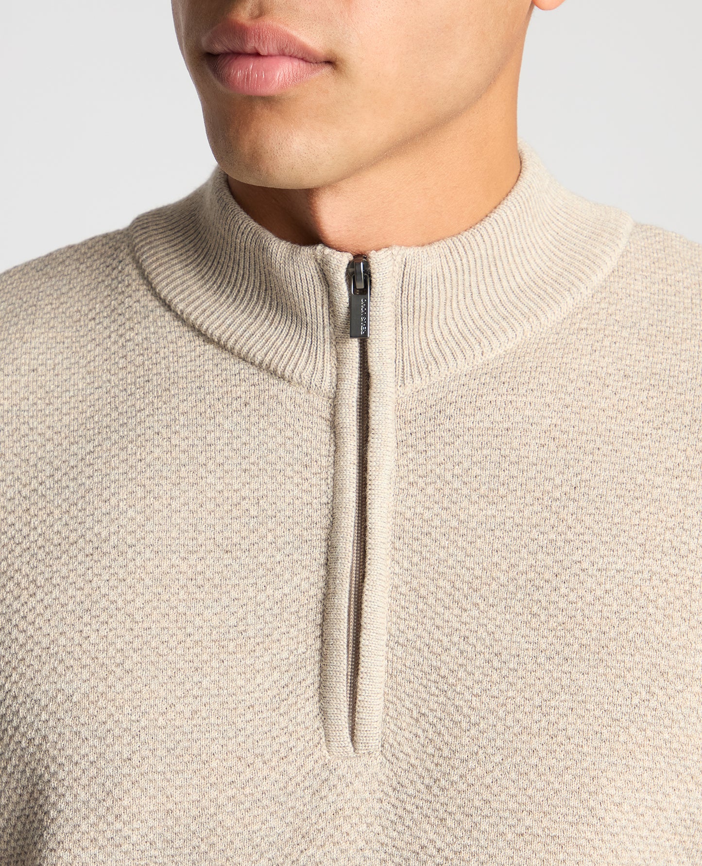 Man wearing a sand Tapered Fit Merino Half Zip Sweater