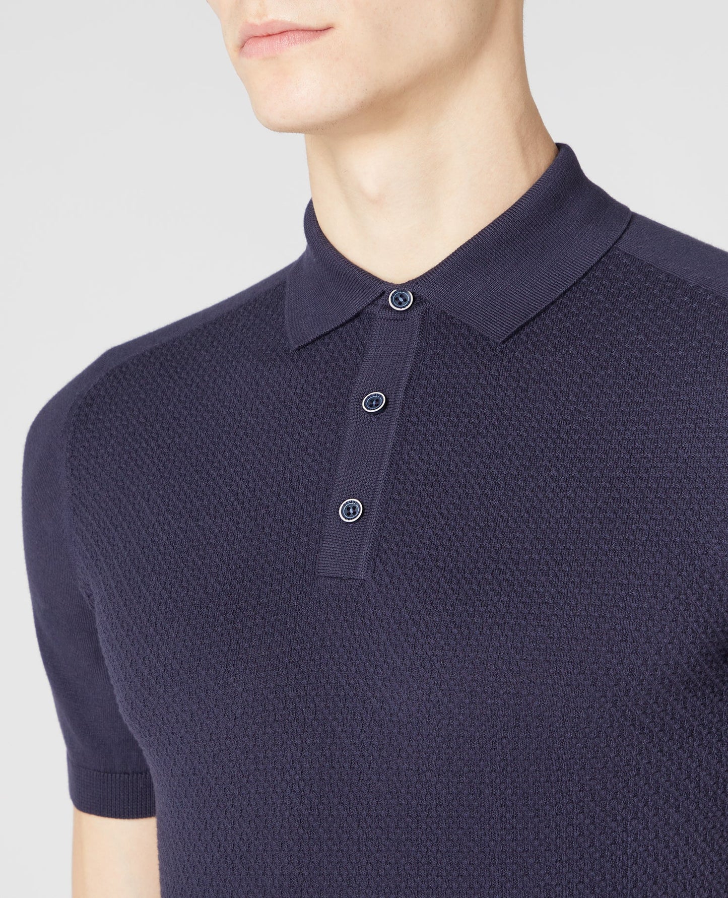 Man wearing a navy Slim Fit Knitted Cotton Short-Sleeve Polo Shirt