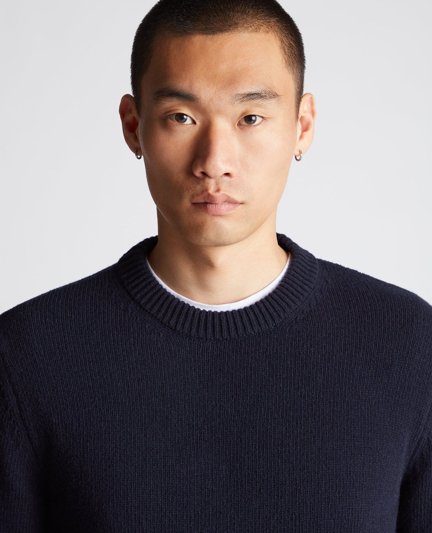 Man wearing a navy Tapered Fit Wool-Blend Crew Neck Sweater