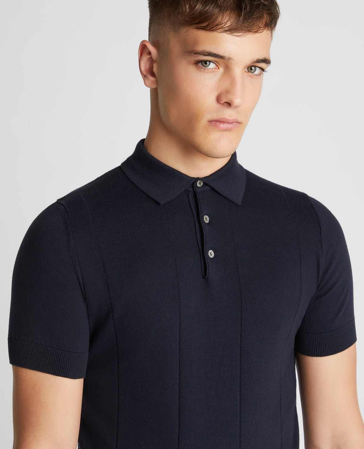 Man wearing a navy Slim Fit Knitted Cotton Short-Sleeve Polo