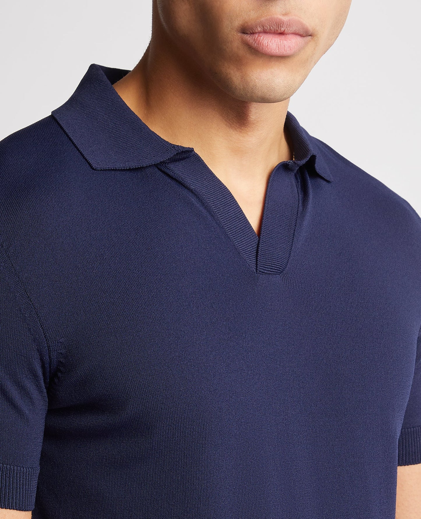 Man wearing a navy Knitted Short-Sleeve Polo