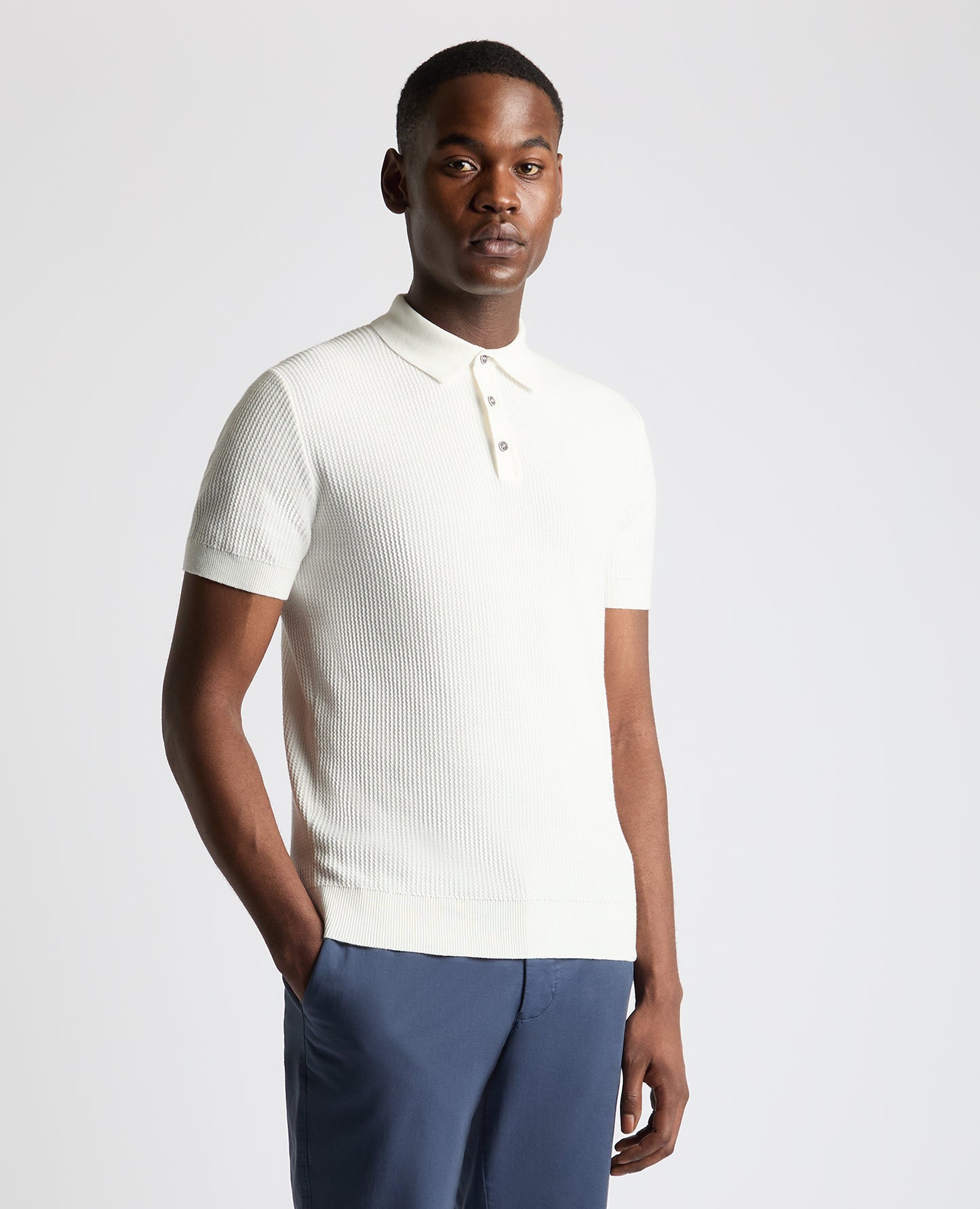 Man wearing a white Slim Fit Cotton Interest Fabric Polo Shirt
