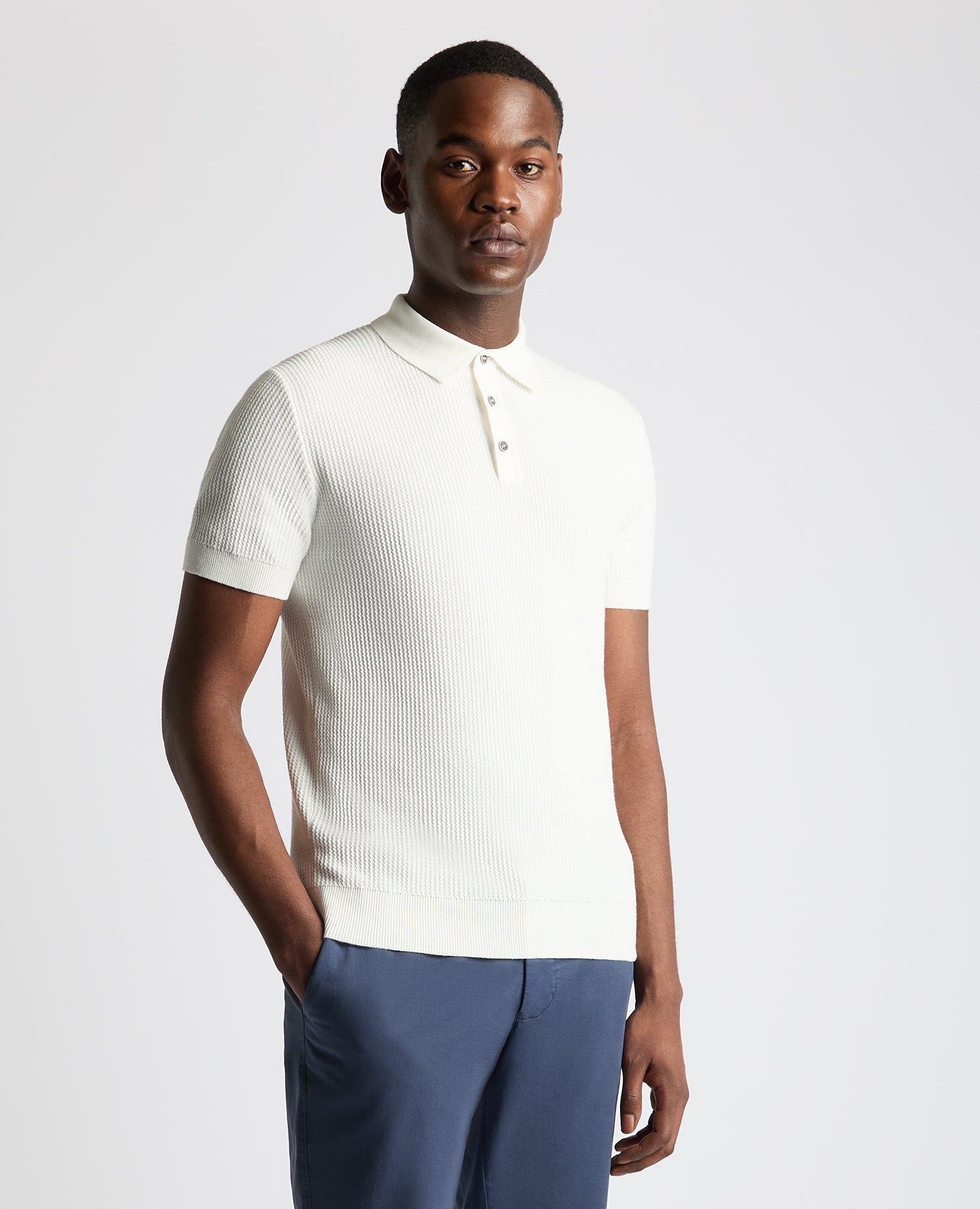 Man wearing a white Slim Fit Cotton Interest Fabric Polo Shirt