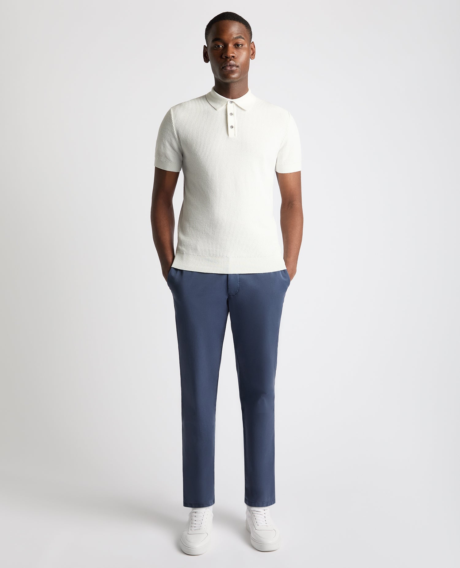 Man wearing a white Slim Fit Cotton Interest Fabric Polo Shirt
