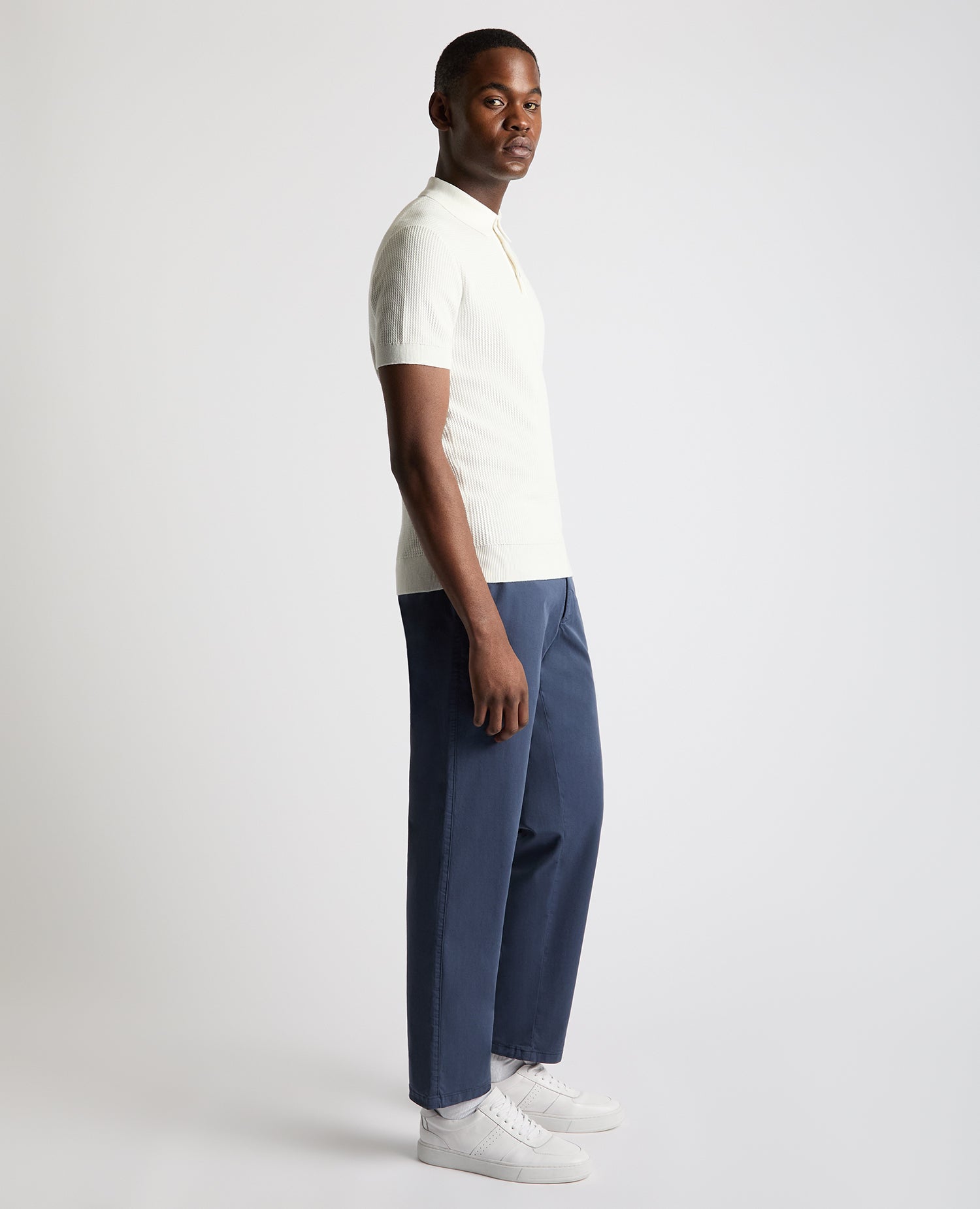 Man wearing a white Slim Fit Cotton Interest Fabric Polo Shirt