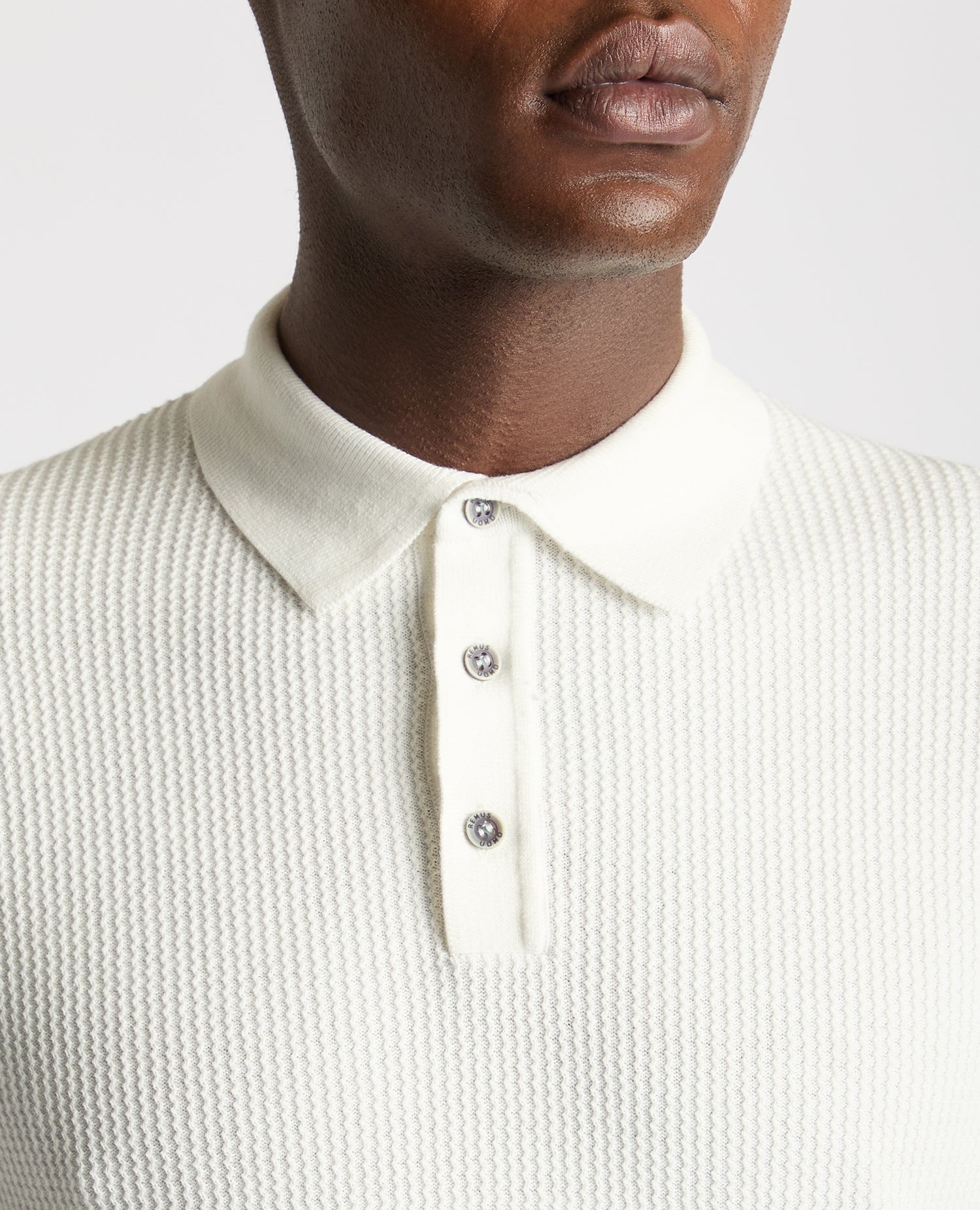 Man wearing a white Slim Fit Cotton Interest Fabric Polo Shirt