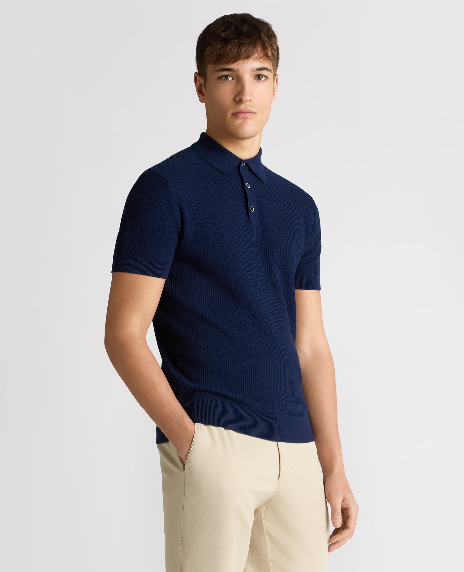 Man wearing a blue Slim Fit Cotton Interest Fabric Polo Shirt