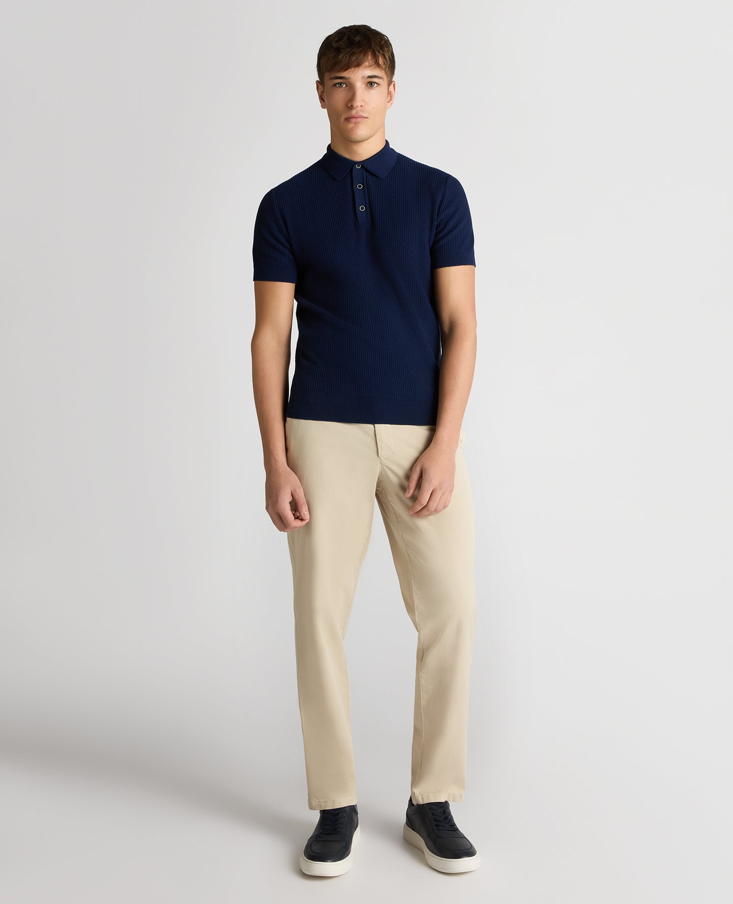 Man wearing a blue Slim Fit Cotton Interest Fabric Polo Shirt