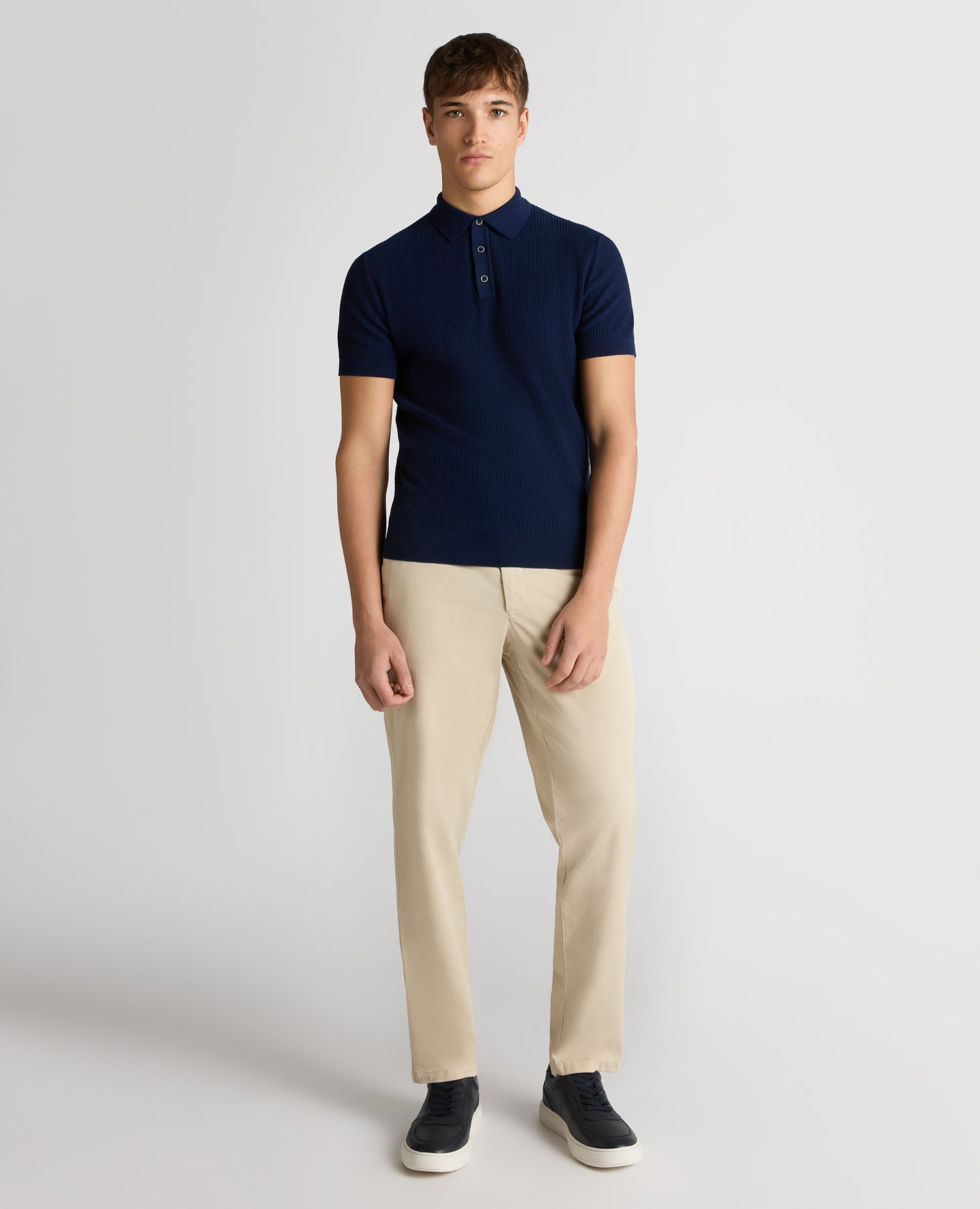 Man wearing a blue Slim Fit Cotton Interest Fabric Polo Shirt