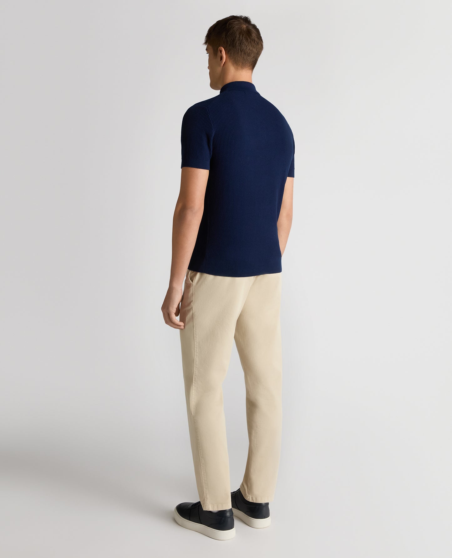Man wearing a blue Slim Fit Cotton Interest Fabric Polo Shirt