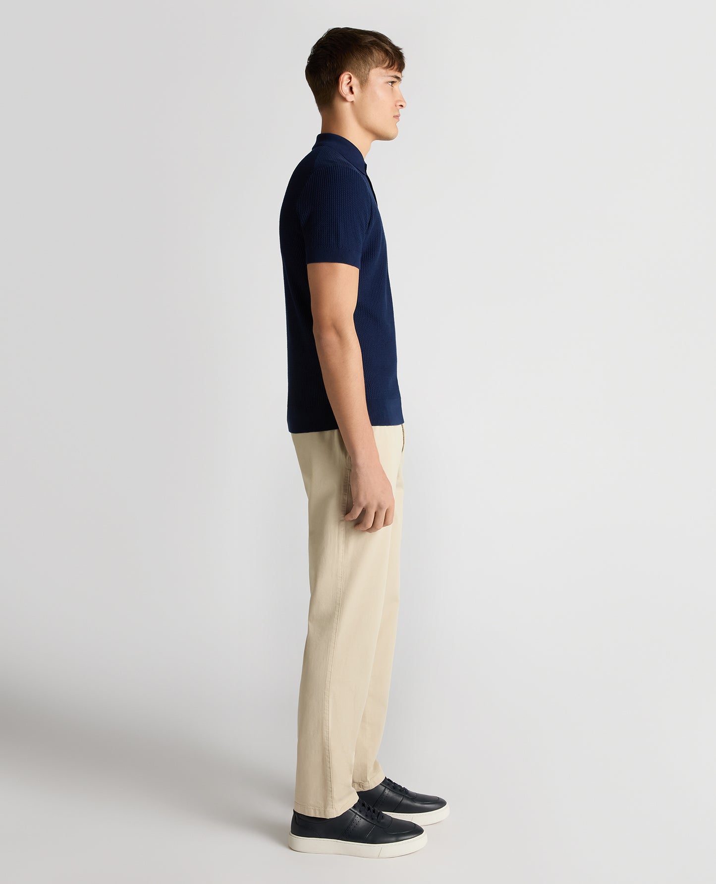 Man wearing a blue Slim Fit Cotton Interest Fabric Polo Shirt