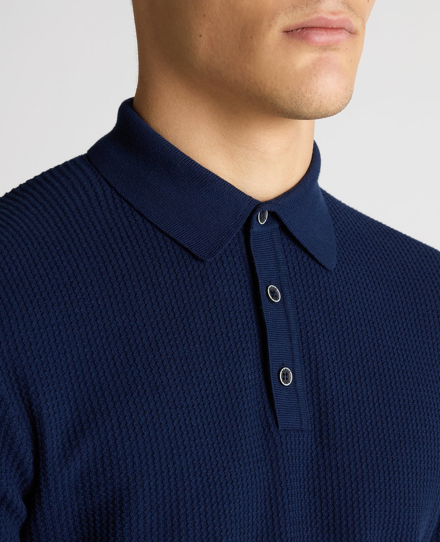 Man wearing a blue Slim Fit Cotton Interest Fabric Polo Shirt