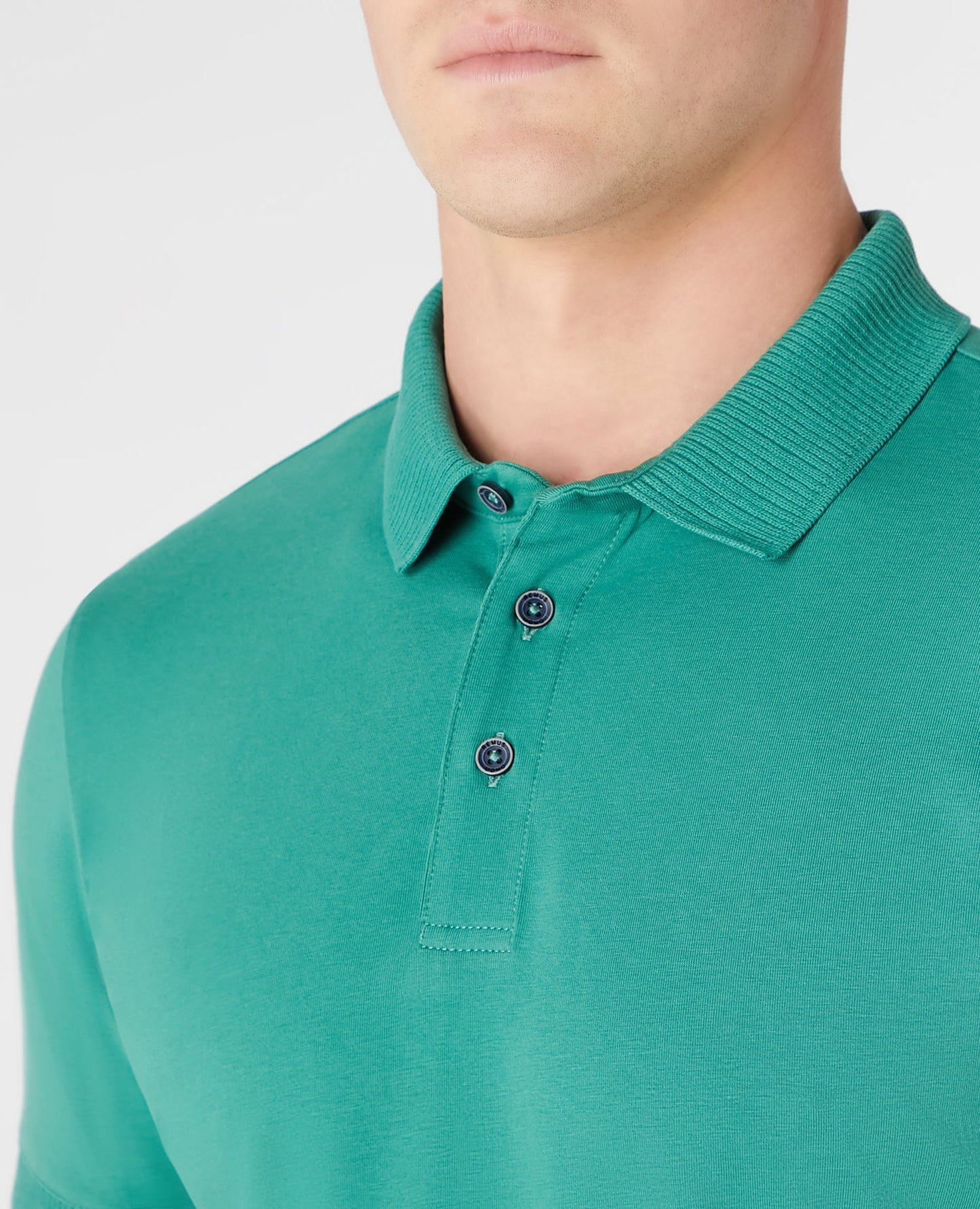 Man wearing a green Tapered Fit Cotton-Stretch Polo Shirt