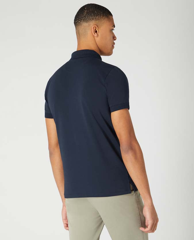 Man wearing a navy Tapered Fit Cotton-Stretch Polo Shirt