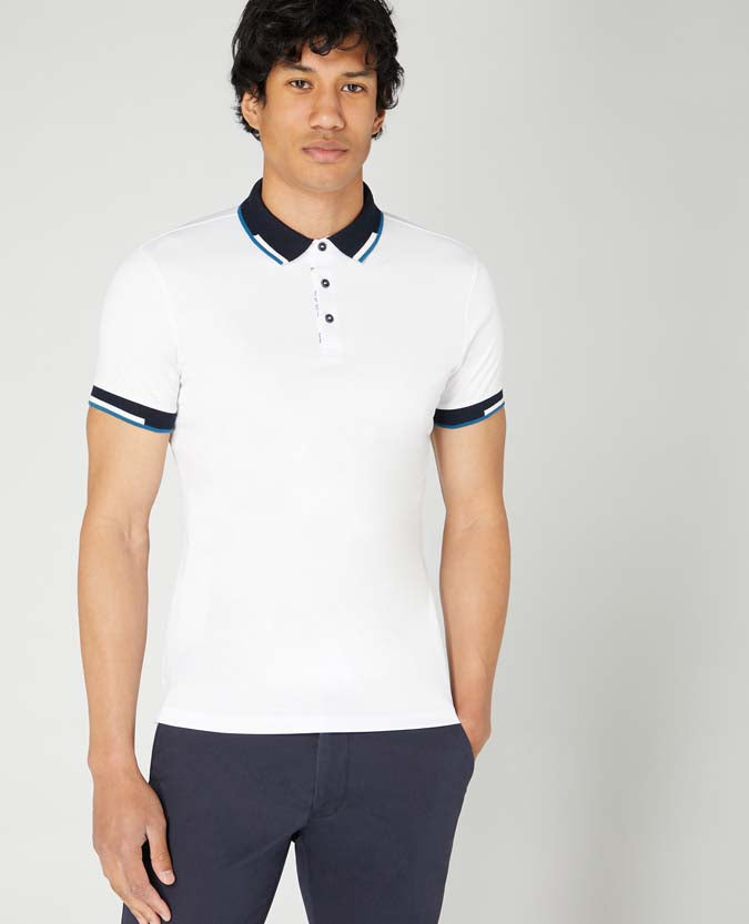 Man wearing a white Tapered Fit Cotton-Stretch Pique Polo Shirt