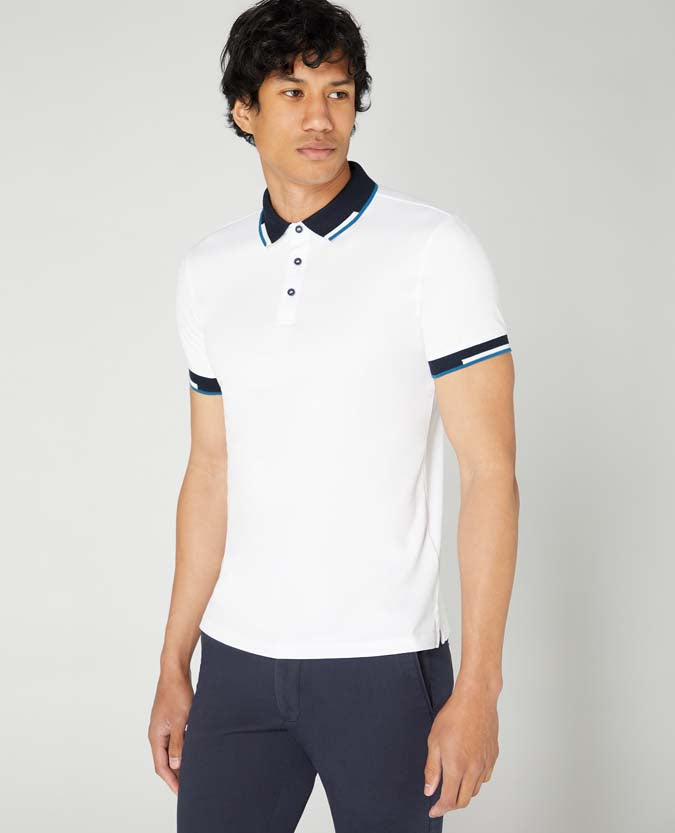 Man wearing a white Tapered Fit Cotton-Stretch Pique Polo Shirt