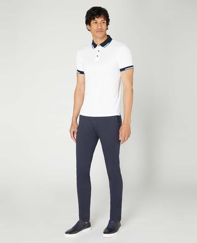 Man wearing a white Tapered Fit Cotton-Stretch Pique Polo Shirt