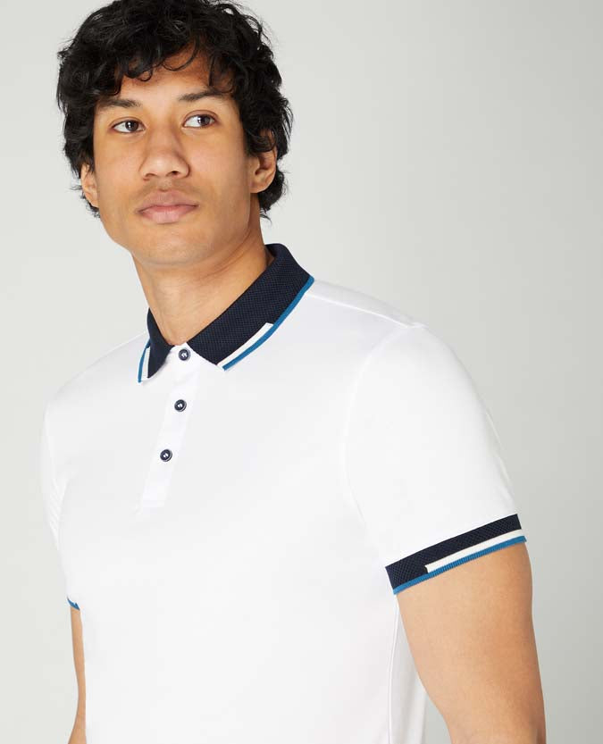 Man wearing a white Tapered Fit Cotton-Stretch Pique Polo Shirt