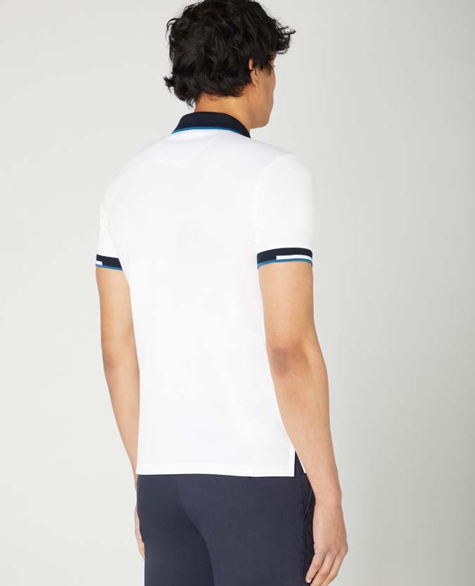 Man wearing a white Tapered Fit Cotton-Stretch Pique Polo Shirt