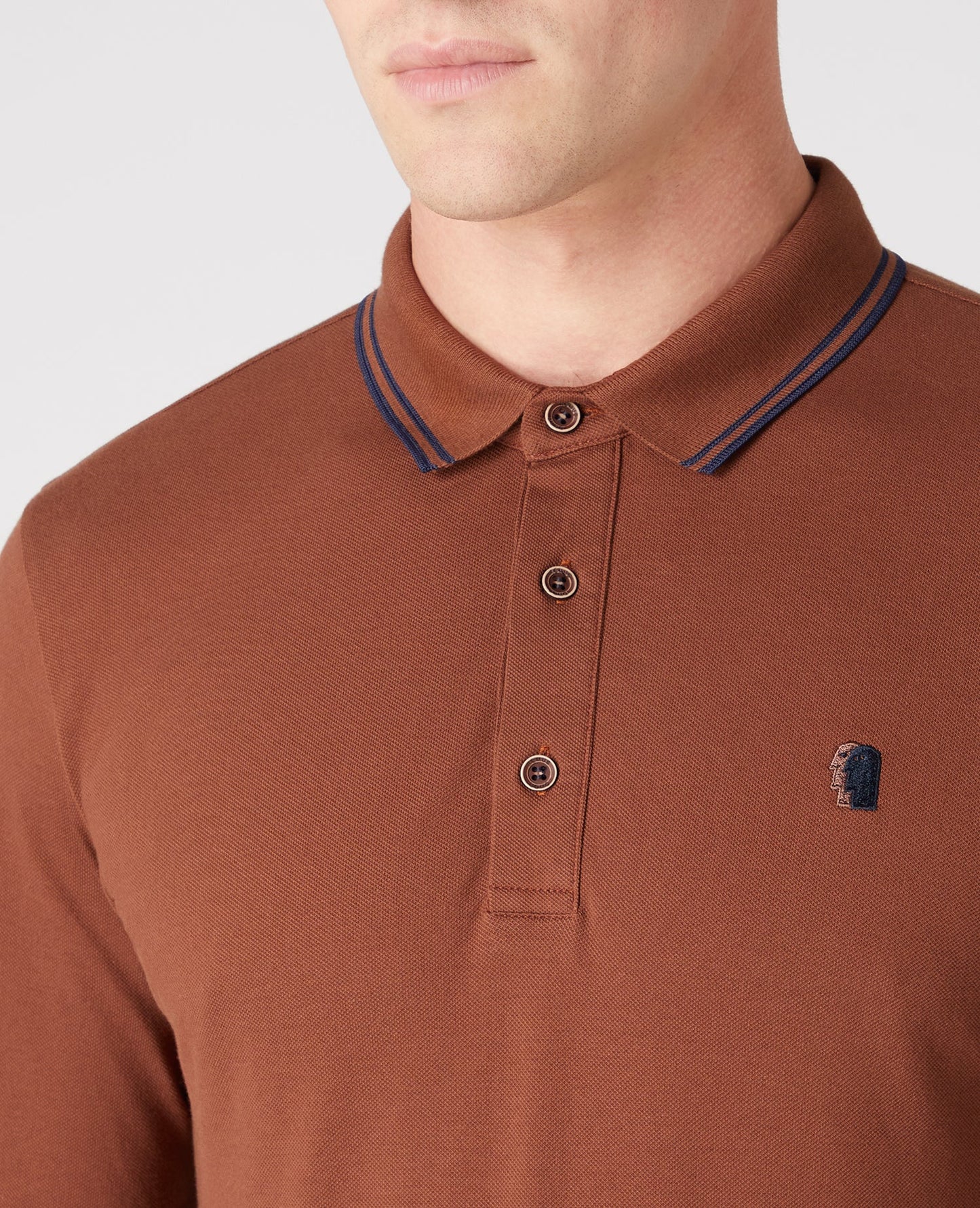 Man wearing a brown Slim Fit Cotton-Stretch Pique Polo Shirt