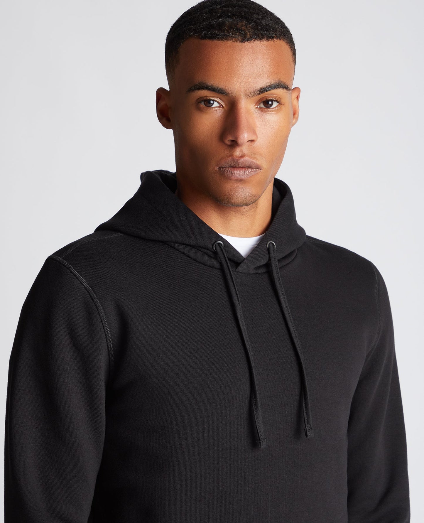Man wearing a black Tapered Fit Cotton-Blend Hoodie