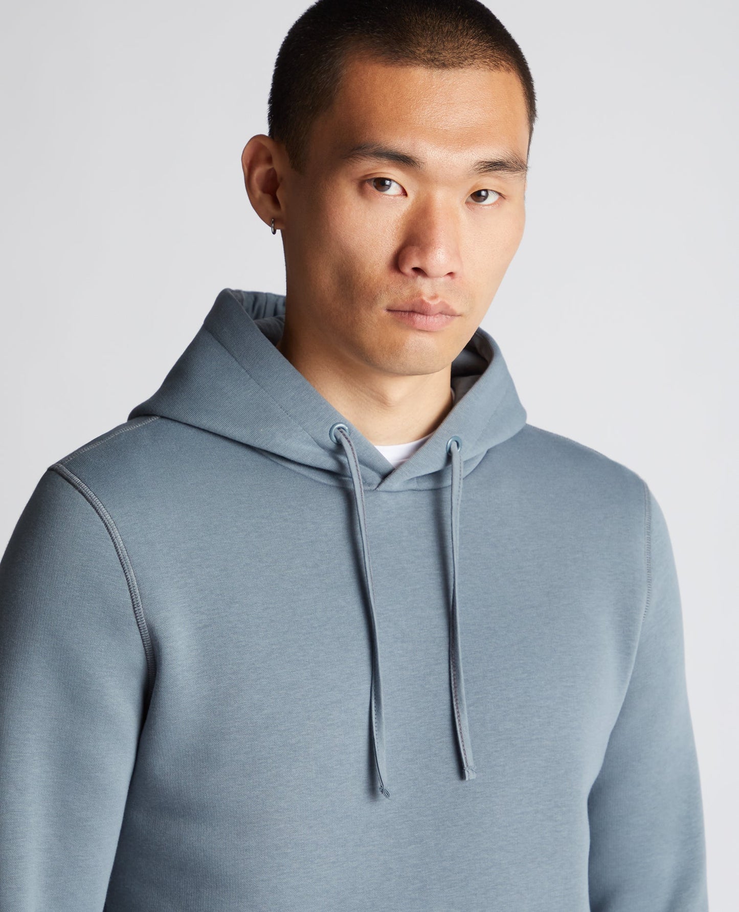 Man wearing a grey Tapered Fit Cotton-Blend Hoodie