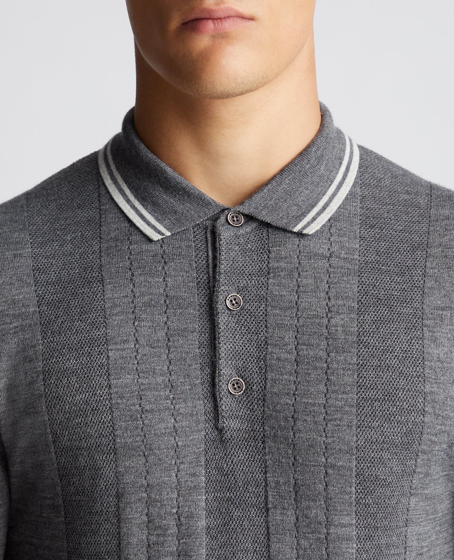 Man wearing a grey Slim Fit Merino Wool Knitted Polo