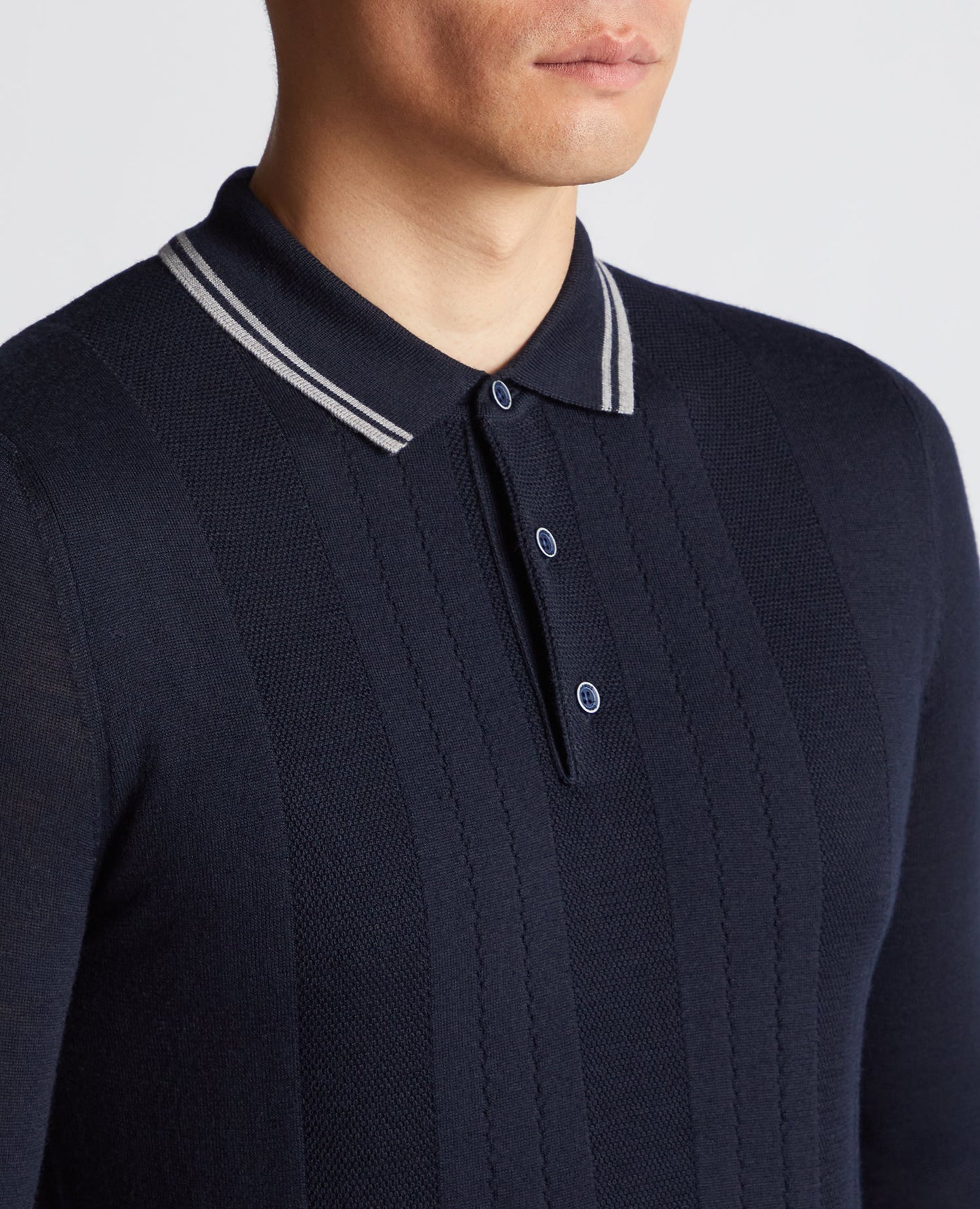 Man wearing a navy Slim Fit Merino Wool Knitted Polo