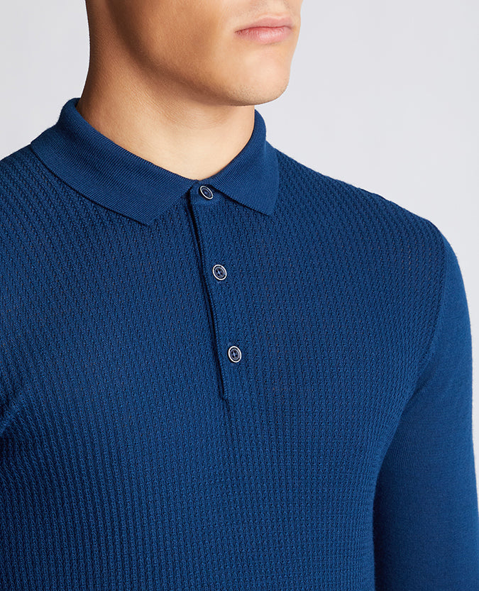 Man wearing a blue Slim Fit Merino Wool-Blend Long Sleeve Knitted Polo