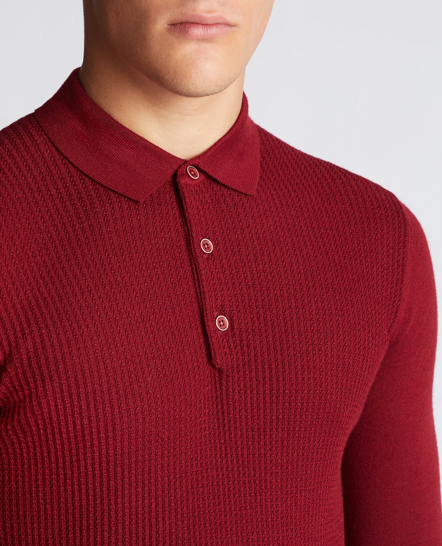 Man wearing a red Slim Fit Merino Wool-Blend Long Sleeve Knitted Polo