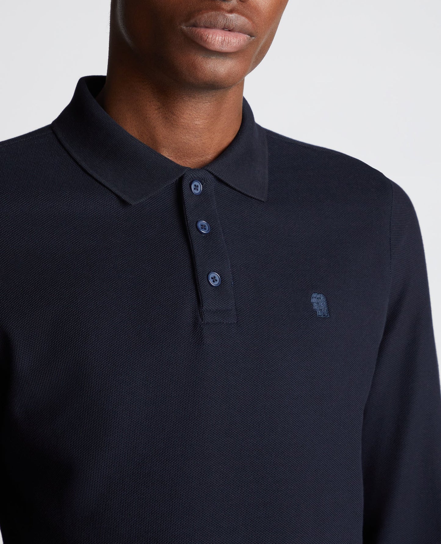 Man wearing a navy Slim Fit Cotton-Stretch Pique Polo Shirt